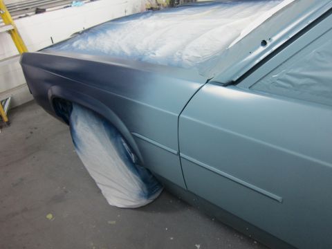 1991 Ford LTD Crown Victoria - Car fender and door covered for painting, showing the side profile of the vehicle.