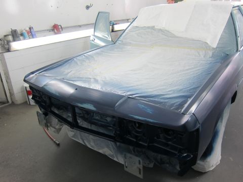 1991 Ford LTD Crown Victoria - A 1991 Ford Crown Victoria LTD is prepped for paint in a body shop, with its front end covered in protective sheeting.