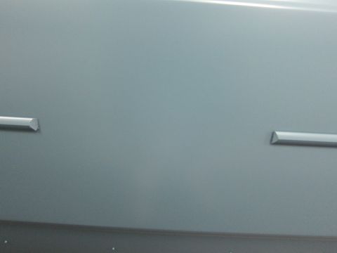 1991 Ford LTD Crown Victoria - Close-up of a car's side panel showing two metallic trim strips.