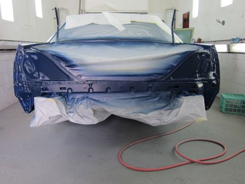 1991 Ford LTD Crown Victoria - Car bodywork covered in protective materials inside a paint spray booth, ready for a new coat of paint.