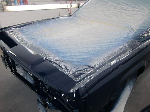 1991 Ford LTD Crown Victoria - A dark blue 1991 Ford Crown Victoria LTD is partially covered in plastic sheeting in a workshop.