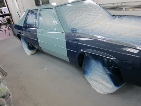 1991 Ford LTD Crown Victoria - Car undergoing paint work, with protective coverings on windows and wheels.