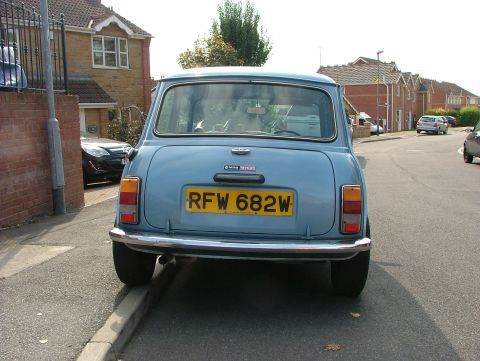 1980 MINI Cooper - Rear view of a blue 1980 MINI Cooper parked on a residential street.