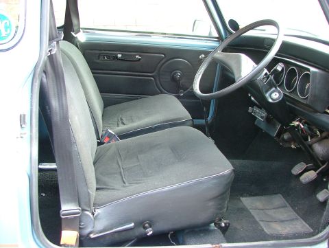 1980 MINI Cooper - The interior of a classic car, seats, steering wheel, and dashboard details.