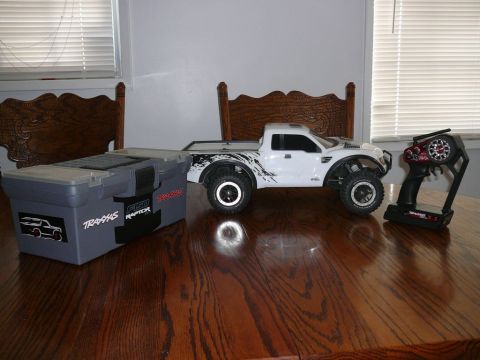 1988 Ford Bronco - A remote control truck and its accessories are displayed on a wooden table.