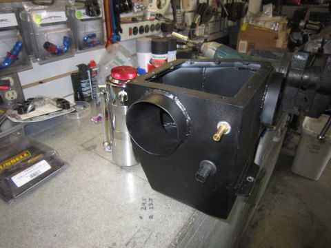 2008 Jeep Wrangler - A custom-made black air intake box is secured in a vise on a workbench, ready for installation.