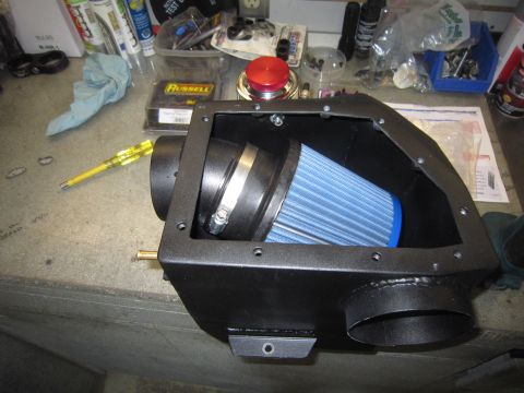2008 Jeep Wrangler - A custom air intake system a blue conical filter within a black housing, likely for a vehicle modification.