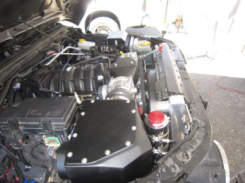 2008 Jeep Wrangler - Engine bay of a Jeep Wrangler showing a supercharger and custom modifications.