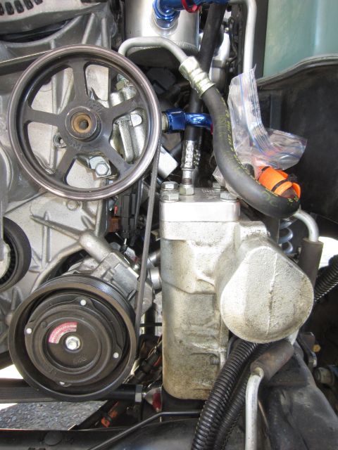 2008 Jeep Wrangler - This image shows various engine components, including a power steering pulley and an air conditioning compressor.