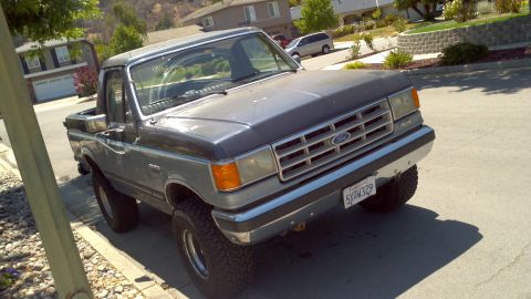 1987 Ford Bronco - This 1987 Ford F-150 pickup truck features a lifted suspension and two-tone paint.