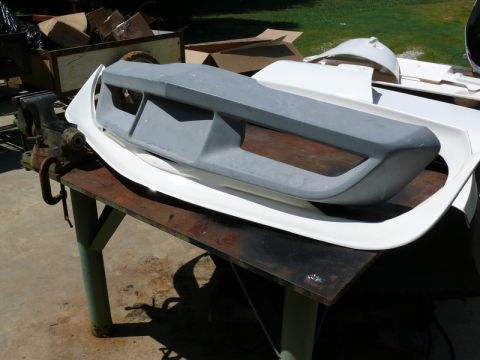 1976 Chevrolet Corvette - Car body kit parts are laid out on a workbench, awaiting installation or modification.