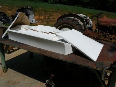 1976 Chevrolet Corvette - A white foam mold for a car part sits on a table, with an old tractor visible behind it.