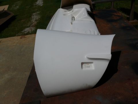 1976 Chevrolet Corvette - A white car fender section is shown, with a rectangular cutout on its surface.