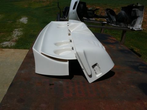 1976 Chevrolet Corvette - Unidentified white car body panels are displayed outdoors on a flat surface.