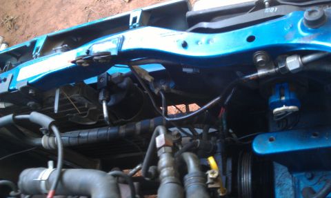 1991 Ford Festiva - Engine bay components including hoses and metal lines are visible in this close-up view.