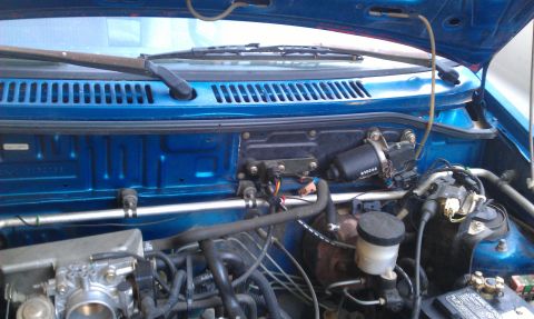 1991 Ford Festiva - Close-up view of engine bay components, including the wiper motor and brake fluid reservoir.