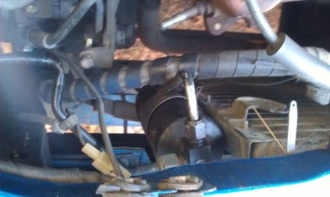 1991 Ford Festiva - Close-up view of engine bay components, including hoses and wiring, with a watermark indicating the source.
