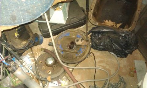 1991 Ford Festiva - Several car brake drums and other automotive parts are visible in this cluttered image.