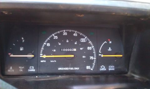 1991 Ford Festiva - The dashboard shows the odometer reading 100,000 miles, with low fuel and normal engine temperature.