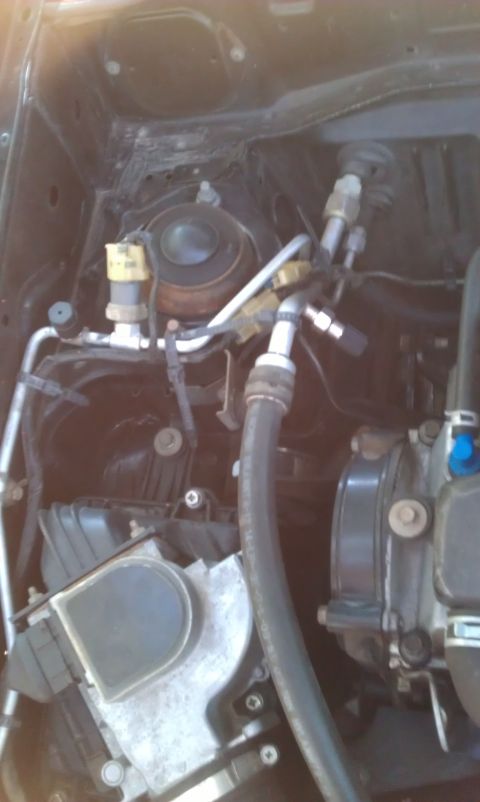 1991 Ford Festiva - Close-up view of engine bay components, including hoses and pipes.
