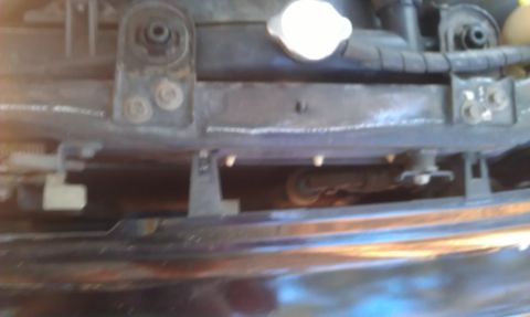 1991 Ford Festiva - Radiator support structure with visible mounting brackets and a coolant cap.