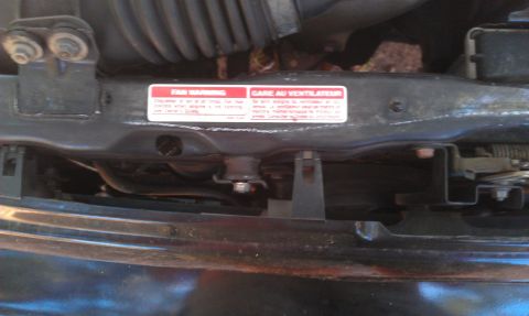 1991 Ford Festiva - Warning labels in the engine bay advise caution around the fan.