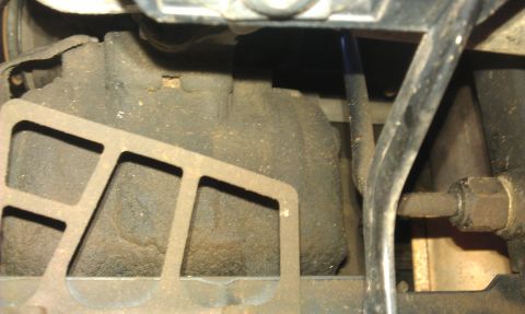 1991 Ford Festiva - A close-up view of a greasy engine component, possibly part of the air conditioning system.