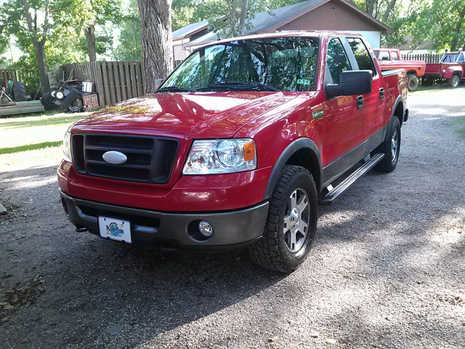 Red 2007 Ford F-150 FX4 parked on gravel, front 3/4 view