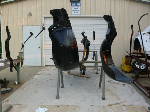 1968 Chevrolet Camaro - Various car parts, including a fender, are suspended and appear to be freshly painted.