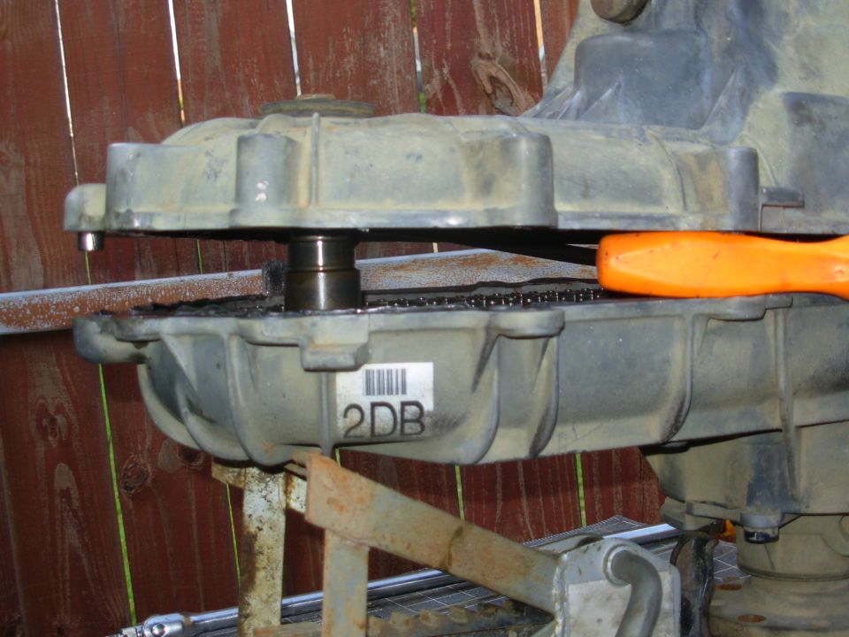 Rather than follow the published procedure, I'm trying this shortcut to inspect/repair the pump stay arm without any extra disassembly.  If it doesn't work, I'll just do it right.  So far, I've removed the front output yoke (1 1/4") and all the casehalf bolts (T50).  I also vacuumed the front output seal to remove all the loose dirt before it fell in on the bearing, and polished the mating surface on the yoke so it can re-seal later.

SEE THE NEXT several pics & their captions...