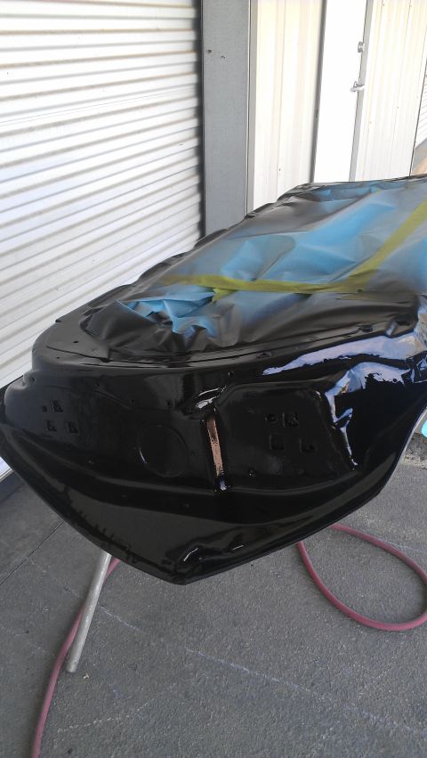 1973 Chevrolet Camaro - A car hood is being prepped for painting, covered in protective materials.