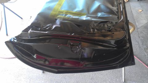 1973 Chevrolet Camaro - Interior of a black car door, taped off for painting.