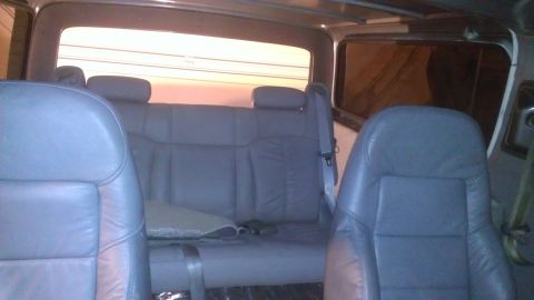 1978 Ford Bronco - Interior view of a vehicle showing gray leather seats and interior panels.