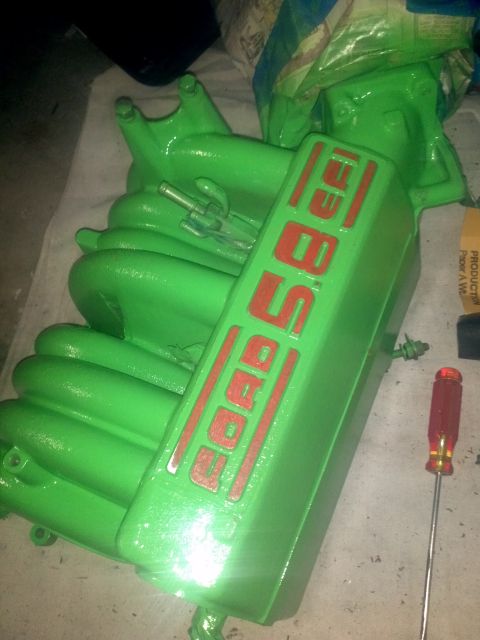 1987 Ford Bronco - A green painted Ford 5.8L engine intake manifold is shown, with red lettering indicating the engine size.