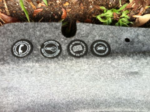 2005 BMW M3 - BMW labels indicate factory pre-wiring for phone, security, CD player, and garage door opener.
