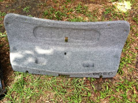 2005 BMW M3 - Trunk liner part, possibly from a BMW, with four circular emblems visible on the side.