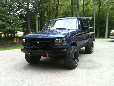 1996 Ford Bronco - This blue 1996 Ford Bronco features a custom front bumper and lifted suspension.