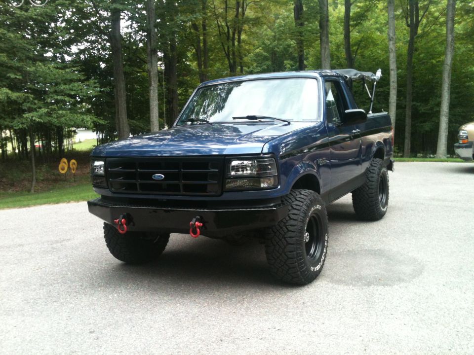 1996 Ford Bronco, blue, with aftermarket front bumper and off-road tires
