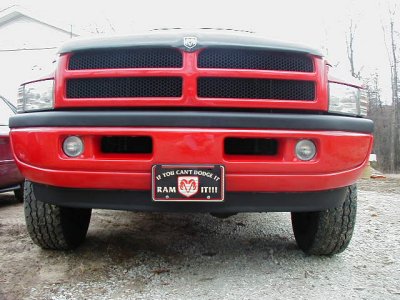 1997 Ford Taurus - This Dodge Ram pickup truck has a custom license plate that reads 'If you can't dodge it, Ram it!'
