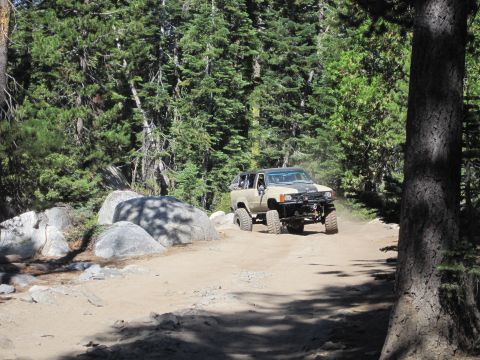 1989 Ford Bronco - A modified Toyota 4Runner navigates a rocky, wooded trail.