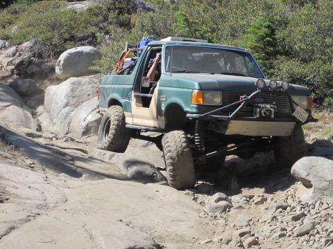 1989 Ford Bronco - Modified 1989 Ford Bronco navigating a challenging rocky terrain.