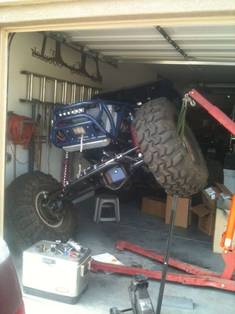 1966 Ford Bronco - Custom off-road buggy with extensive modifications is being worked on in a garage, suspended by a hoist.