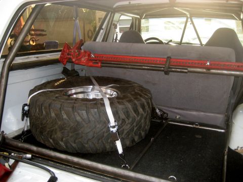 1996 Ford Bronco - Spare tire and hi-lift jack secured in the cargo area of a 1996 Ford Bronco.