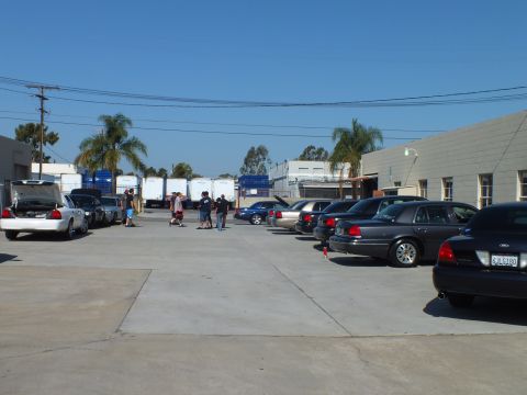 2003 Ford Crown Victoria - Crown Victoria and Grand Marquis sedans parked at a meet, freight containers behind