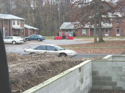 1997 Ford Taurus - A silver sedan is visible on a street with apartment buildings and a construction site in the background.