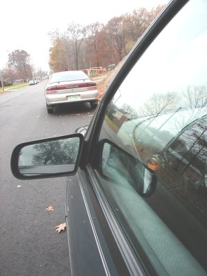 1997 Ford Taurus - A 1997 Ford Taurus is seen parked on a residential street, with another vehicle visible in the foreground.