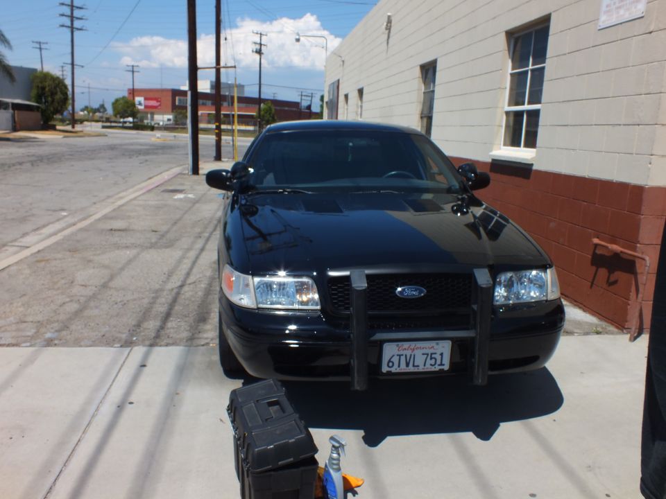 Front of black Ford Crown Victoria with push bar and California plate 6TVL751
