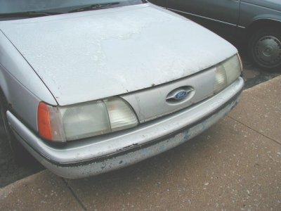 1997 Ford Taurus - Front end of a silver 1997 Ford Taurus, parked next to another vehicle.