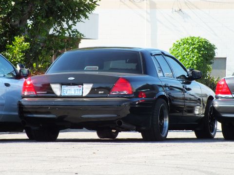 2003 Ford Crown Victoria - Lowered black Crown Victoria with SVT badge, dark wheels and Washington EVTL VTC plate