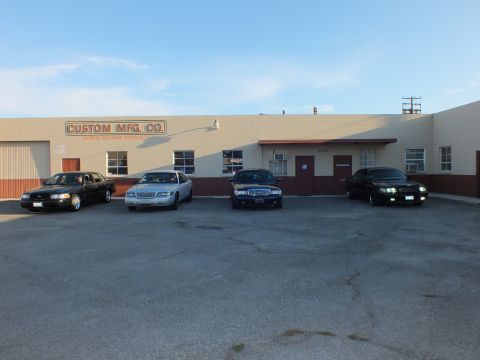 2003 Ford Crown Victoria - Four full-size sedans line up outside the Custom Mfg. Co. screw machine products shop